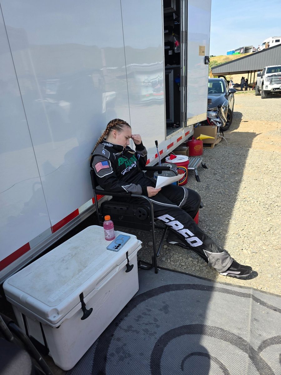 Jaelin Rapp, navigator of #36, studying the course sheet in her race suit